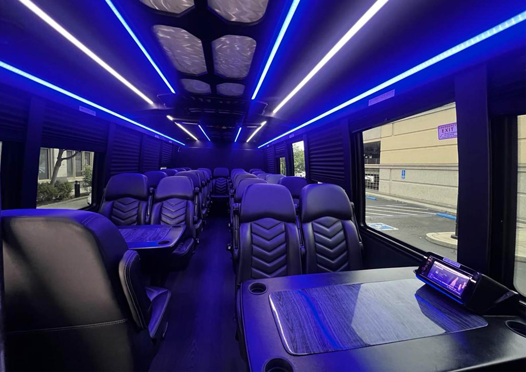 Interior of luxury executive shuttle with premium leather seats and blue LED lighting