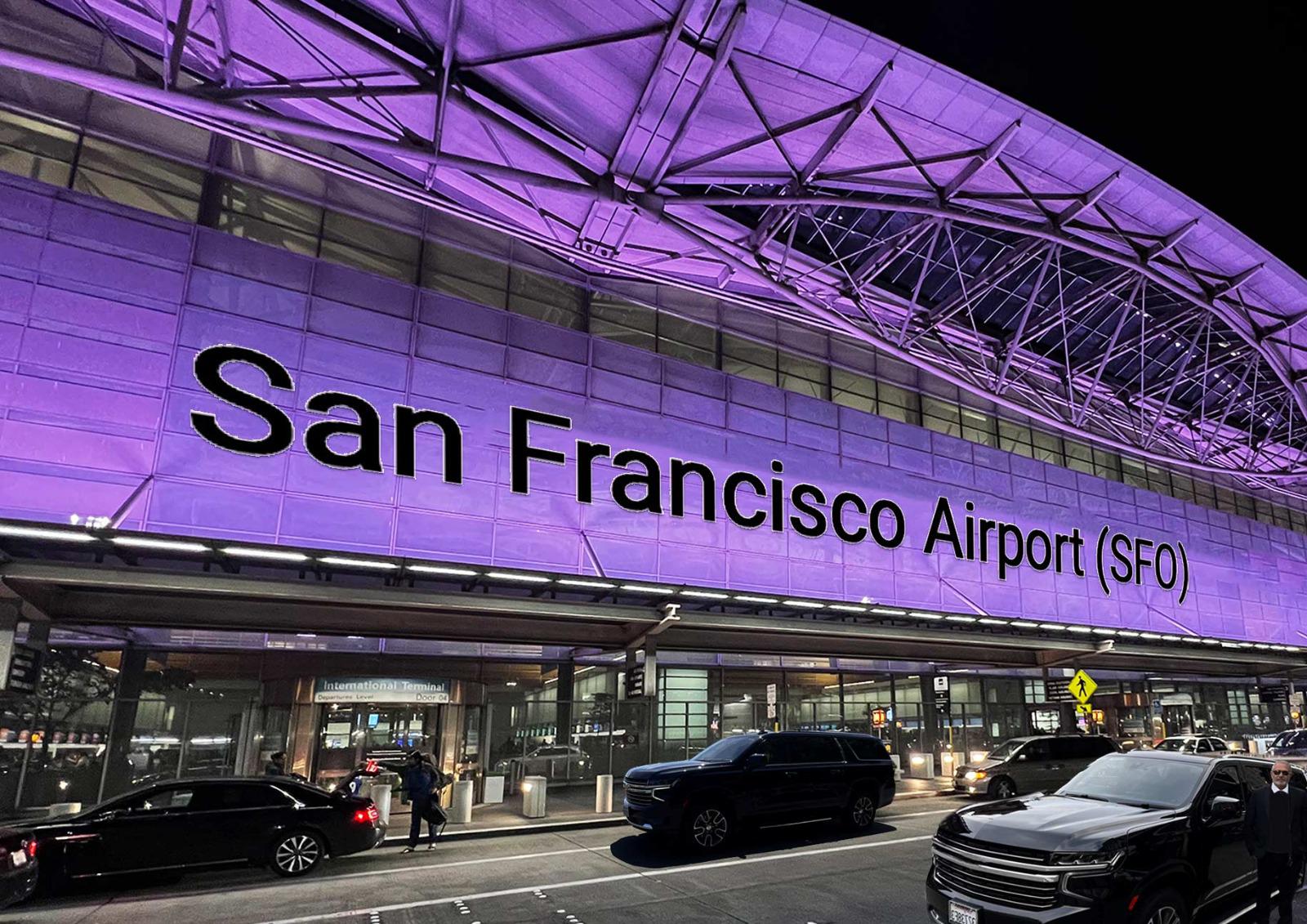 San Francisco Airport (SFO) illuminated at night with luxury black vehicles parked at the terminal, highlighting premium limo and car service.