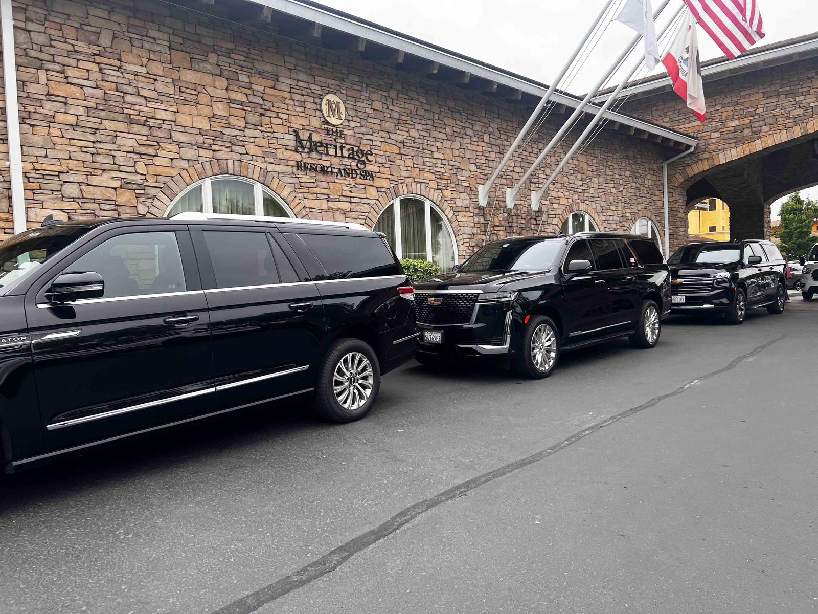 Luxury black SUVs lined up at The Meritage Resort, ready for VIP transportation